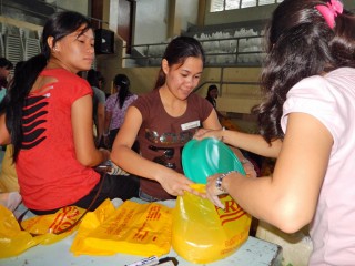 Filipino Christians help assemble food packets.