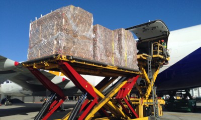 Cartons of shoeboxes are loaded onto the cargo jet.
