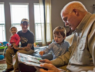 Pat Fleming reads to 3-year-old Elliott Paterson as Nathan and Layla watch.