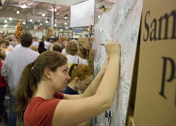 Volunteers write encouraging messages on a banner that will be sent to people suffering in the aftermath of Typhoon Haiyan in the Philippines.