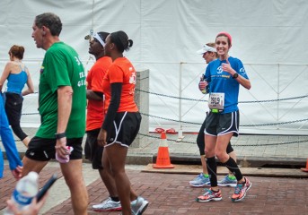 Rachel Redlien gives a thumbs up after she finishes the half-marathon.