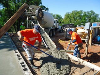 A crew pours the foundation of a new home.
