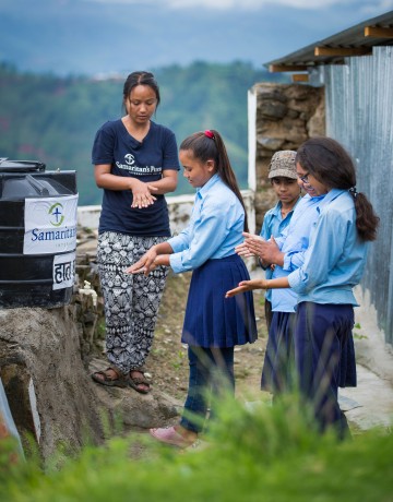 Staff member Sujana Lama teaches hand-washing techniques to schoolchildren as part of our clean water, sanitation, and hygiene project.