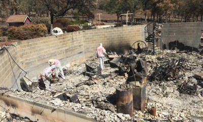 Samaritan's Purse volunteers search through the ruins of a home destroyed by the Valley Fire.