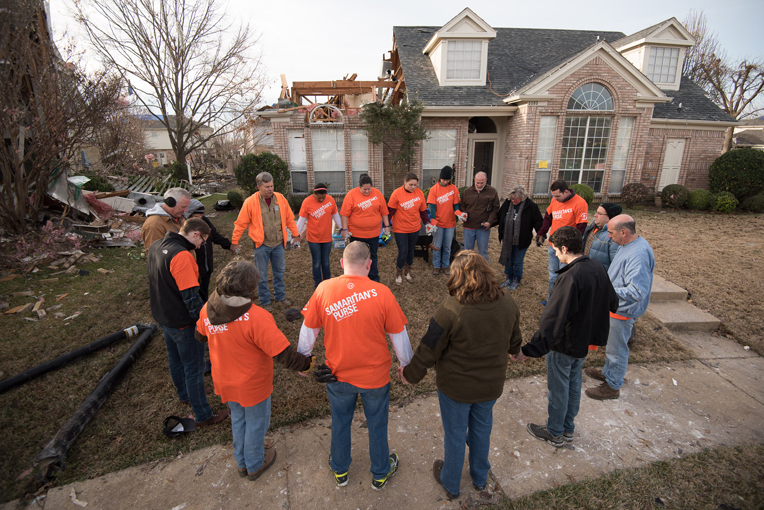 Samaritan's Purse volunteers pray with homeowners