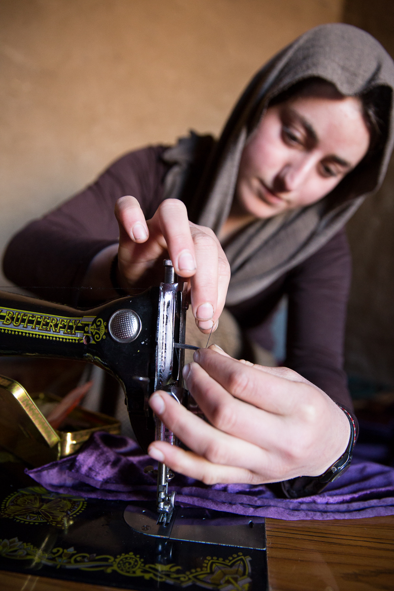 A women sews intently at Grace Community Center in northern Iraq, a ministry of Samaritan's Purse.  We are working with men, women, and children who have fled ISIS>