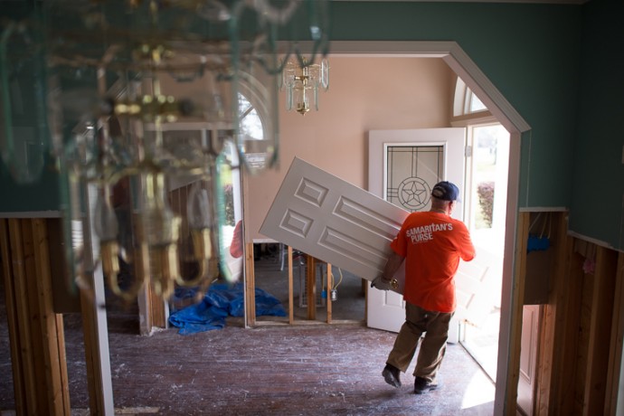 A Samaritan's Purse volunteer removes items from a flooded home in north Louisiana. 