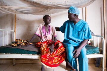 Dr. Evan Atar speaks with a patient at the Maban County Hospital in South Sudan.