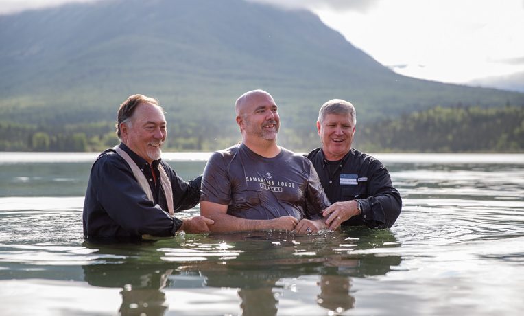 Army Sergeant Ben Decker is baptized by Chaplains Jim Fisher (left) and Steven Keith (right).