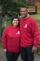 Ralph and Yesica Harris in their Alabama Crimson Tide sweatshirts at Samaritan Lodge Alaska.