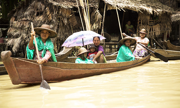 Burmese women in a boat during the monsoon floods