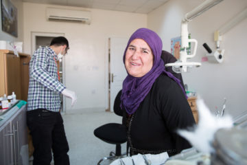 Iraqi woman smiling after dental care
