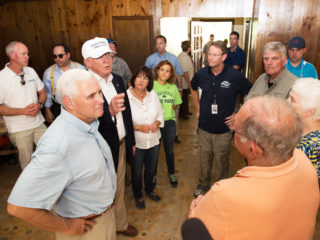 Indiana Governor Mike Pence, Republican presidential candidate Donald Trump, and Franklin Graham speak with homeowners. Karen Pence (white shirt) and Tony Perkins (dark blue shirt) are also pictured.