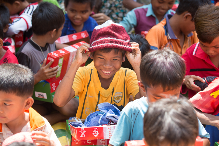 Boy wearing a hat he received in his shoebox