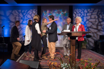 Dr. Joe Woods was surprised by his adult children on stage as he received this year's “In the Footsteps of the Great Physician” award.