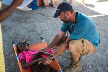 Dr. Steve Harvey prays with cholera patients at our Cholera Treatment Center in Chardonnières, Haiti.
