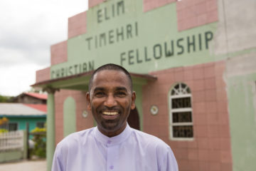 Pastor Sammy stands outside his church in Guyana.