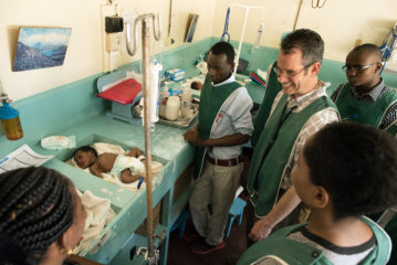 Dr. Roskos and hospital staff in pediatric ward.