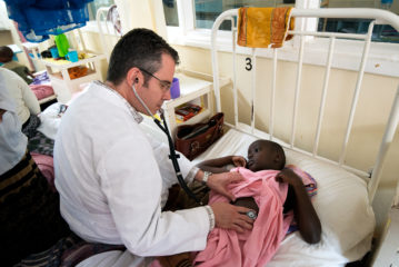 Dr. Roskos examines a young patient.