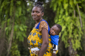 Kpana and Jonna pose for a portrait after the 1-year-old had successful surgery. Kpana said her neighbors will no longer refer to Jonna as an evil spirit. 