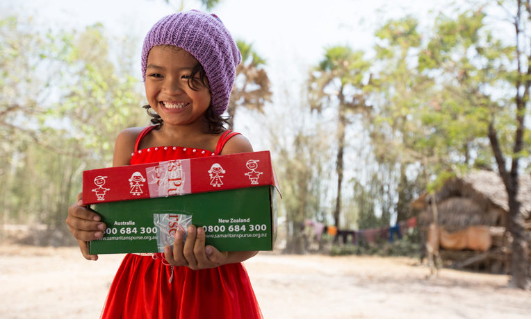 Cambodian child with Operation Christmas Child shoebox gift