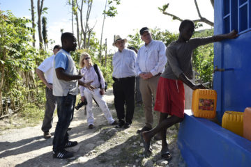Greta Van Susteren, John Coale, and Franklin Graham inspect a restored water point in Bon Bon, Haiti.