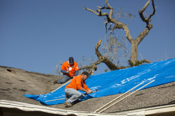 Volunteers tarp a roof in Albany, Georgia. 
