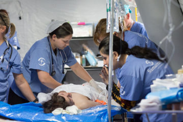 Serving in Mosul--Field hospital staff assess a patient's injuries.