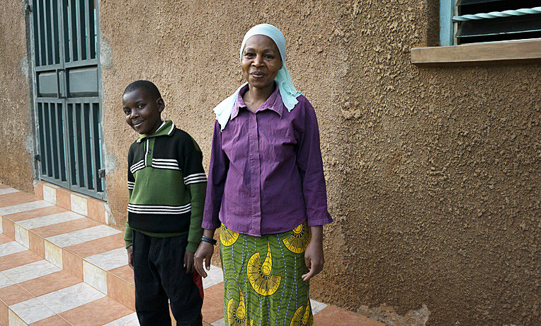 Clinton and Mary, his mom, smile in front of their new church home.