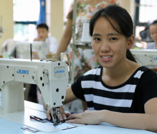 Vietnamese woman attends vocational school to learn sewing and embroidery.