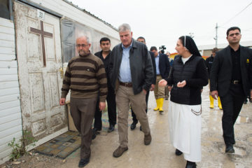 Franklin Graham walks alongside Sister Diana at a camp for Christians displaced by ISIS.