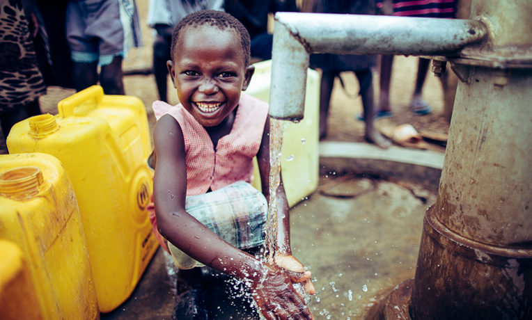 A young refugee in the Bidibidi Refugee Resettlement washes her hands.