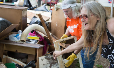 Homeowner Tammy Mellon goes through belongings salvaged from her flooded home by Samaritan’s Purse volunteers, including Roberta Kallay from Lawrenceburg, Indiana.