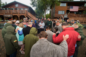 Samaritan's Purse Franklin Graham prays for Operation Heal Our Patriots participants after baptisms on July 7. 