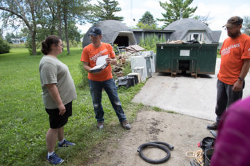 Our team members presented a Bible to homeowner Kristy Beaudette after work at her flooded property.