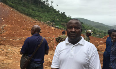 The earth behind survivor Daniel Moijueh shows the aftermath of devastating flooding that claimed seven family members.