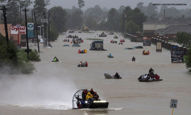 People evacuate east Houston by boat.