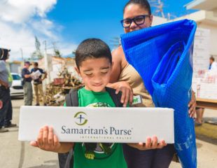 Rayda Cortes and her 6-year-old son Leon received emergency relief items during a distribution at Good Samaritan Church.