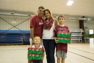 Matthew and Angel Bass and their sons, Logan, 10, and Preston, 3, brought items to pack shoeboxes for children in need.  