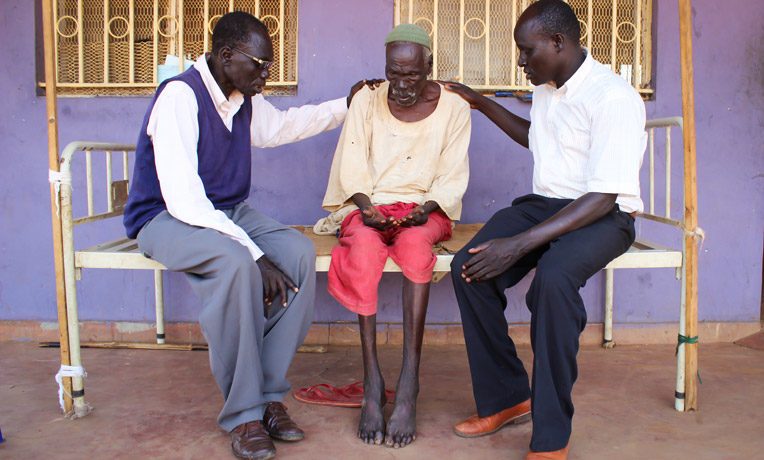 Two local pastors in northeast South Sudan pray for a patient at Maban County Hospital. As part of our Crisis Counseling program, on average more than 1,000 patients and their caregivers are counseled, encouraged and prayed for every month.