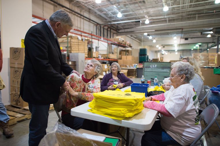 Franklin Graham greets volunteers at the Operation Christmas Child shoebox processing center in Charlotte.