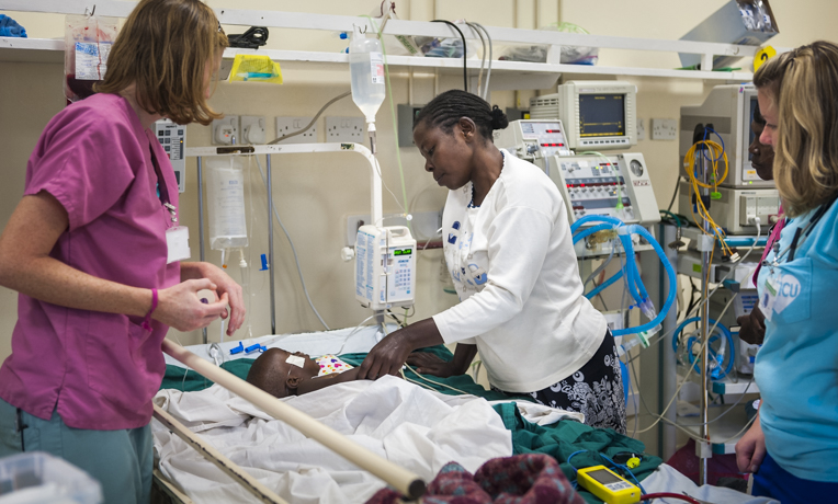 Tenwek Hospital in Kenya serves patients in Jesus' Name. Christian mission hospital staff attend to a patient