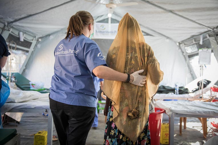 Samaritan's Purse staffer offers a steadying hand to a diphtheria patient.