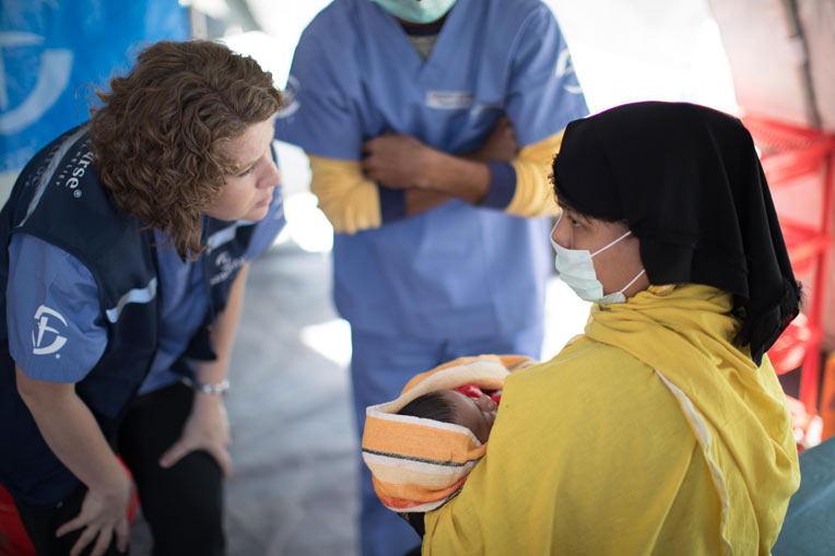 A member of our medical team speaks with a mother at the treatment center.