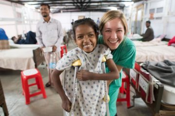 Erin Stephenson, a nurse serving through Samaritan's Purse, smiles with her patient at Memorial Christian Hospital. 