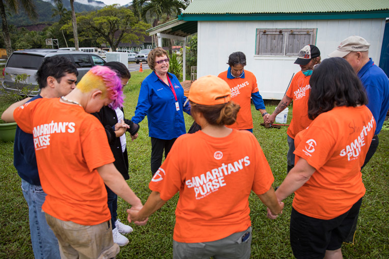 Volunteer Samaritan's Purse Billy Graham Rapid Response Team chaplain prayer with homeowner