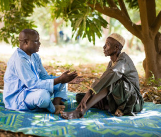 Abdou Issa and Ibrahim Sani discuss scripture under a mango tree. Ibrahim was led to salvation in Jesus Christ after Abdou preached the Gospel in his village.