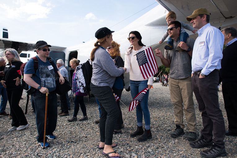 Will Graham, vice president of the Billy Graham Evangelistic Association, joins Cissie Graham Lynch and husband Corey Lynch in greeting military couples as they deplane at Samaritan Lodge.
