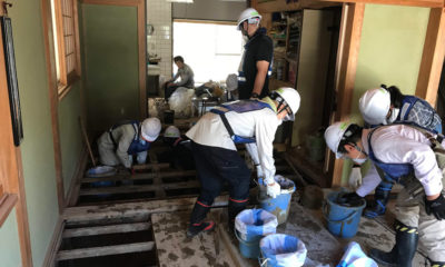 Volunteers mobilized by local churches work to clean up a flood-affected home.