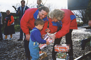 Pastor Ross and Carol Rhoads hand out shoebox gifts to children in Eastern Europe in 1993.
